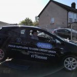 Rupert Christie sitting in the car door closed