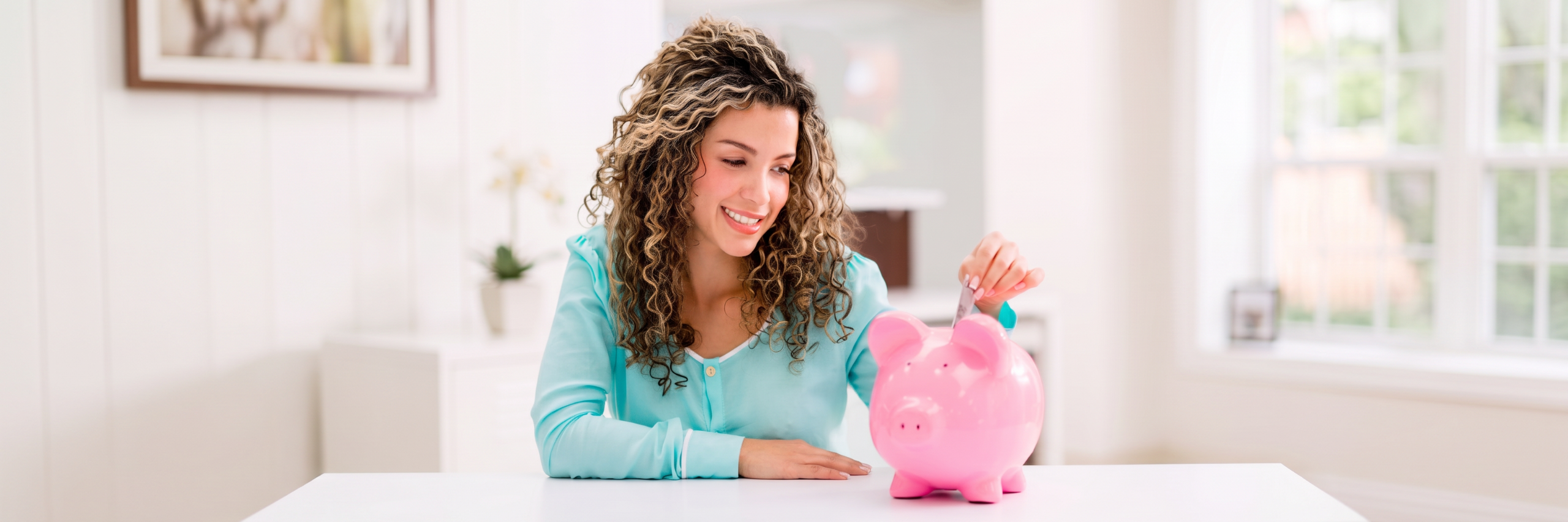 Lady saving money in a piggy bank